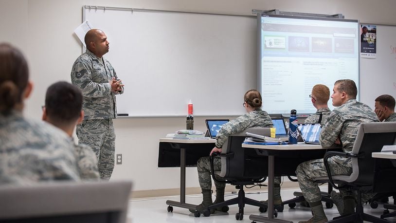 Tech. Sgt. Ricardo Lemos Rodriguez, NCO in charge of the Force Health Management Branch, mentors the Public Health apprentice students to prepare them for the operational Air Force. He discusses how they can navigate the Air Force Portal to locate information on Air Force priorities, career development and education. (U.S. Air Force photo/Richard Eldridge)