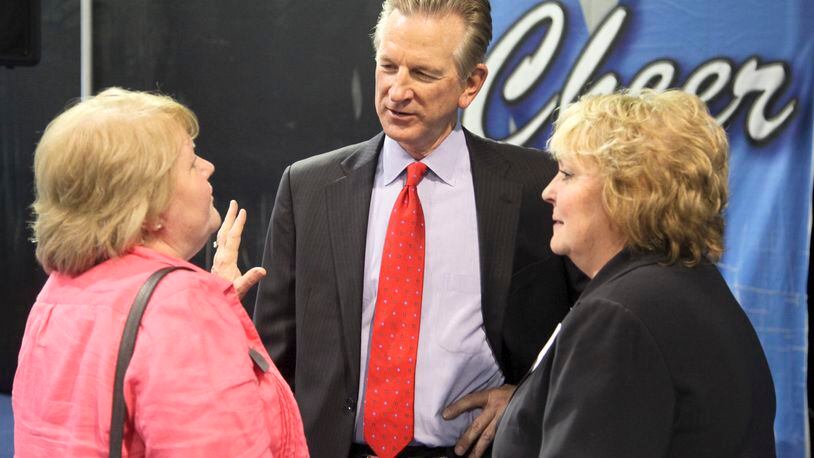 University of Cincinnati head football coach Tommy Tuberville, center, speaks with Lakota School Board President Joan Powell and Superintendent Karen Mantia during the annual West Chester-Liberty Chamber Alliance Regional Business Expo held at Skatetown USA, Tuesday, May 14, 2013. GREG LYNCH / STAFF
