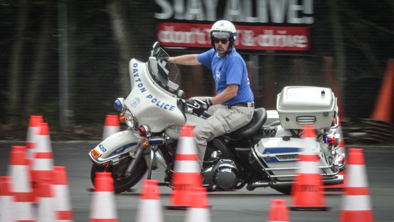 Dayton Police motor officer instructor, Jack Miniard runs through the training course in Moraine Wednesday morning.