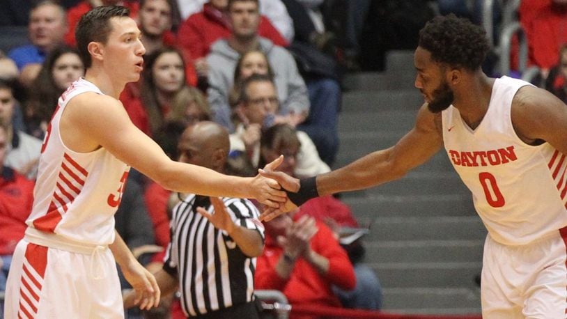 Dayton’s Ryan Mikesell and Josh Cunningham slap hands after a stop against Western Michigan on Wednesday, Dec. 19, 2018, at UD Arena. David Jablonski/Staff