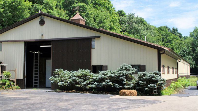 A circular driveway and parking space precede the Tecumseh stable at a short distance from the home. The two horse barns, with 8 stalls, a foaling stall and room for more, connect to an indoor heated arena of 10,500 square feet. Other features include a viewing room, a kitchenette, a bathroom and a laundry room. There are 2 outdoor paddocks.