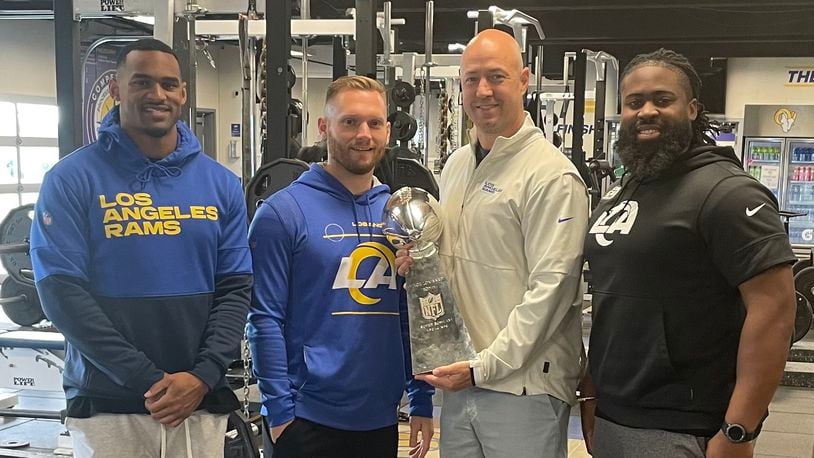 Rams staffers John Griffin, Zach Witherspoon, Justin Lovett and Jamel Cooper pose with the Vince Lombardi Trophy. Lovett is a Beaverceek High School grad. (Photo contributed)