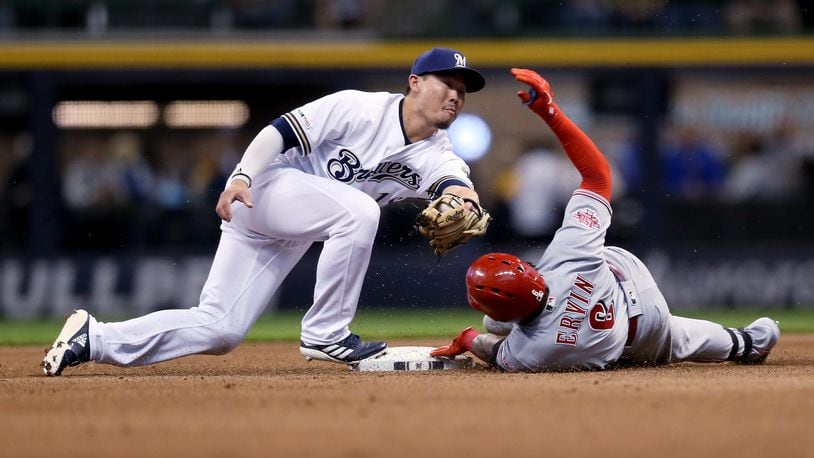 MILWAUKEE, WISCONSIN - MAY 21:  Phillip Ervin #6 of the Cincinnati Reds slides into second base for a double past Keston Hiura #18 of the Milwaukee Brewers in the first inning at Miller Park on May 21, 2019 in Milwaukee, Wisconsin. (Photo by Dylan Buell/Getty Images)