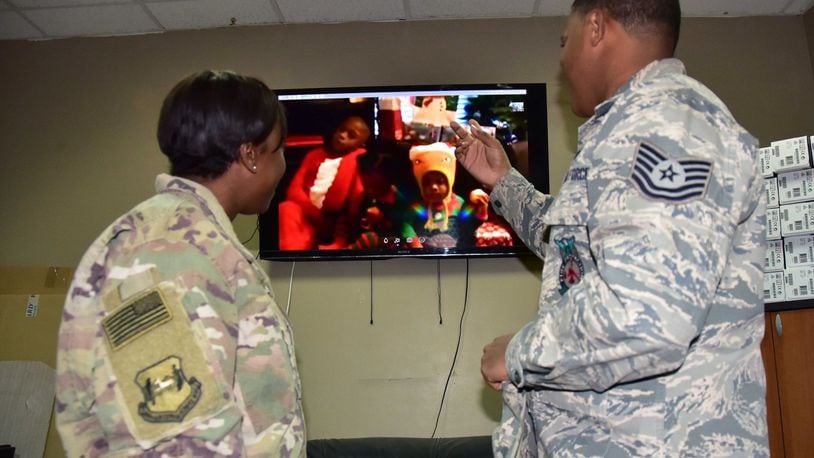 Master Sgt. Shalenna Mitchell, 386th Air Expeditionary Wing finance budget analyst and Tech. Sgt. Randle Mitchell, 386th Expeditionary Civil Engineering Squadron assistant chief of fire prevention, video chat with their children Dec. 21, 2017, as they do daily while on deployment at an undisclosed location in Southwest Asia. (U.S. Air Force photo/Tech. Sgt. Louis Vega Jr.)