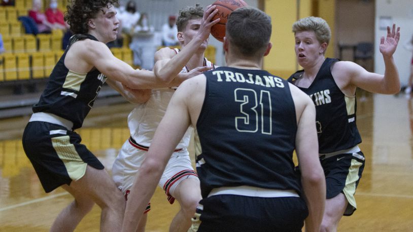 Bokins starters Carter Pleiman (left), Jacob Pleiman (31) and Zane Paul surround Cedarville's Trent Koning in the regional final last Friday. The Trojans will face Richmond Heights at 11 a.m. Friday in the Division IV state semifinal at UD Arena. Jeff Gilbert/CONTRIBUTED