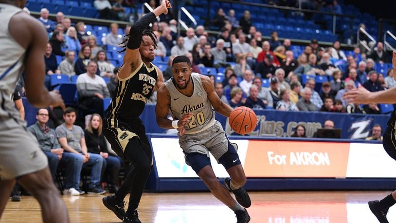 Akron’s Xeyrius Williams drives against Western Michigan’s Brandon Johnson during a game earlier this season. University of Akron photo