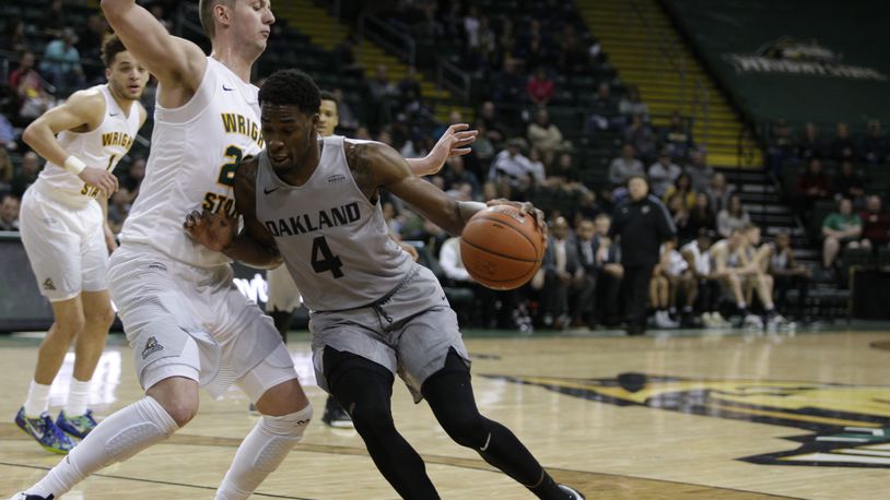 Wright State’s Parker Ernsthausen defends against Oakland’s Jalen Hayes during the Raiders’ 88-67 win Sunday at the Nutter Center. TIM ZECHAR/SUBMITTED PHOTO