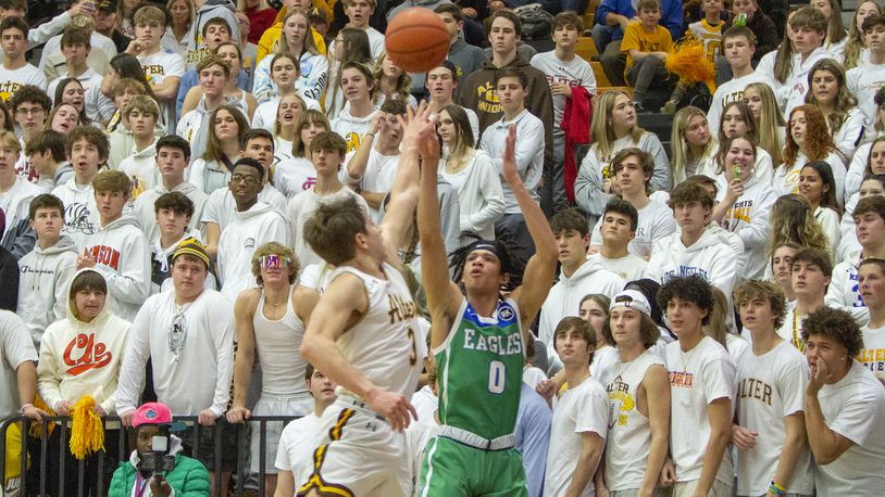 Chaminade Julienne's Evan Dickey shoots from 3-point range over Alter's Anthony Ruffolo during CJ's 77-70 victory Friday night at Centerville High School. Dickey made four 3-pointers and scored 20 points. CONTRIBUTED/Jeff Gilbert