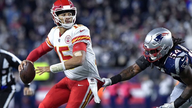 Kansas City Chiefs quarterback Patrick Mahomes throws an interception in the end zone under pressure from New England Patriots linebacker Dont’a Hightower in the closing seconds of the second quarter on Sunday, Oct. 14, 2018 at Gillette Stadium in Foxborough, Mass. (John Sleezer/Kansas City Star/TNS)