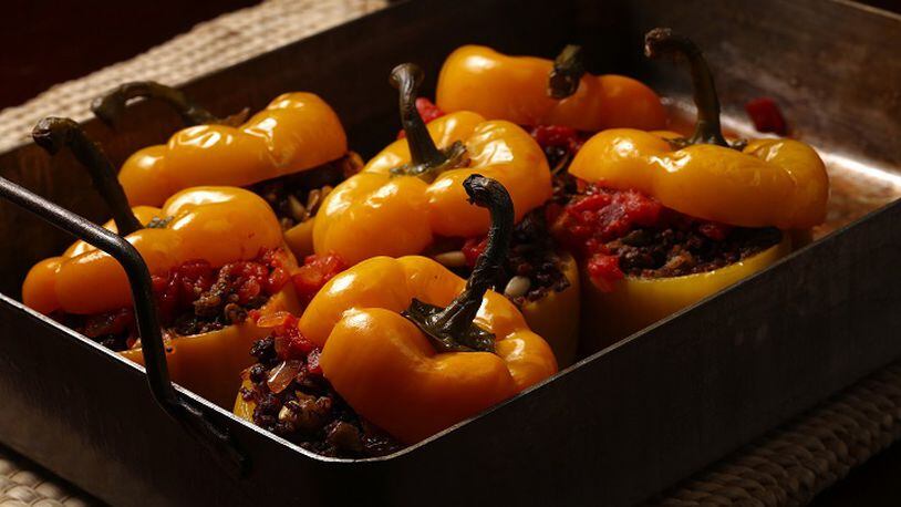 Serbian style stuffed red bell peppers are filled with ground beef, onion, peppers, garlic, pine nuts, rice and raisins.(E. Jason Wambsgans/Chicago Tribune/TNS)
