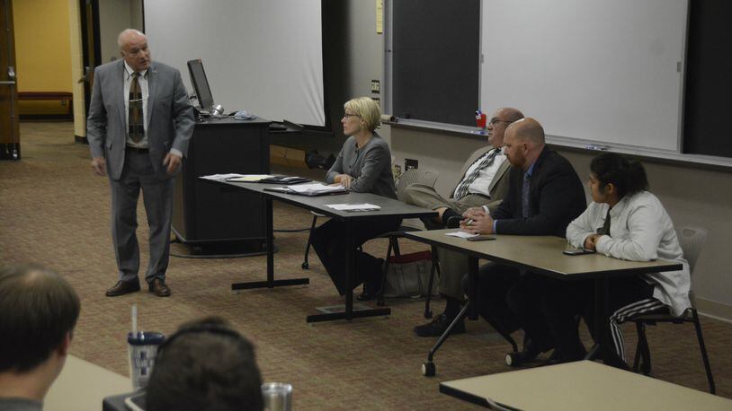 Butler County Prosecutor Mike Gmoser (standing) addresses an Ohio State University student during a panel discussion on Ohio Issue 1 at Miami University Regionals in Hamilton.