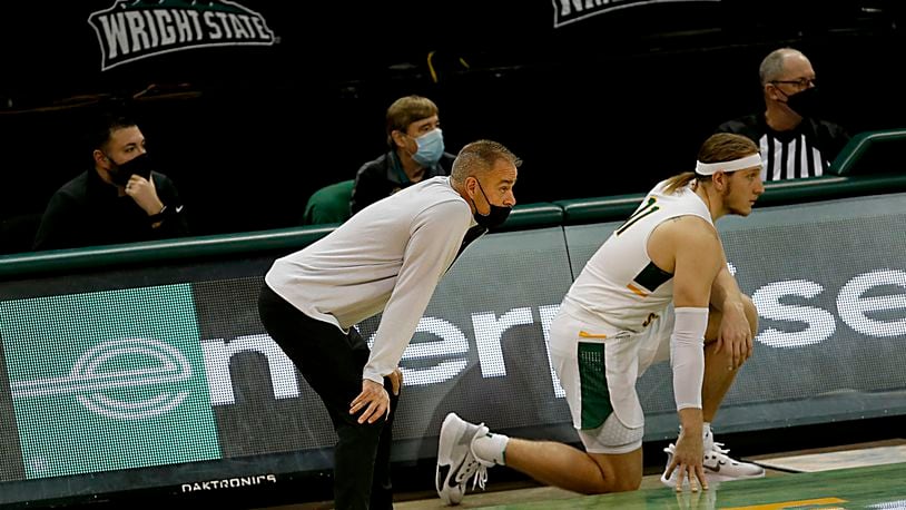 Wright State head coach Scott Nagy, center, watches the action against Green Bay as center Loudon Love waits to reenter during a men's basketball game at the Nutter Center in Fairborn Saturday, Dec. 26, 2020. E.L. Hubbard/CONTRIBUTED