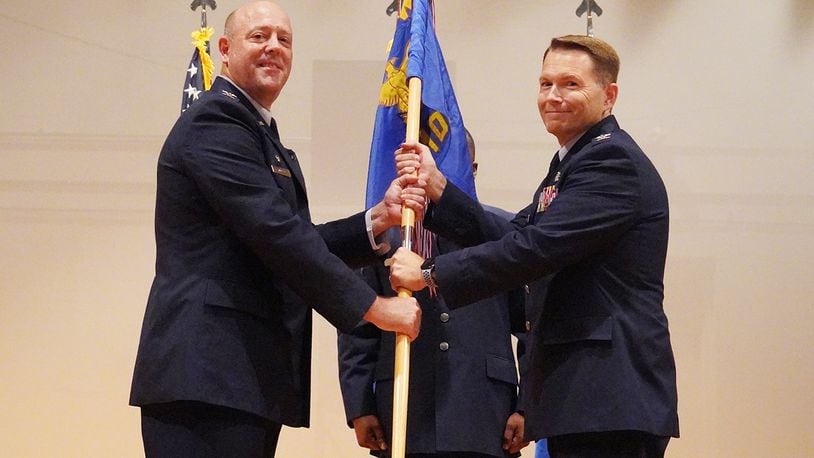 Col. Patrick Miller (left), then-88th Air Base Wing commander, passes the 88th Medical Group guidon to Col. Dale Harrell during an assumption of command ceremony July 7 at Wright-Patterson Air Force Base. Harrell previously served as the 78th Medical Group commander at Robins Air Force Base, Georgia. He assumes command from Col. Christian Lyons, who’s leaving for the Air Force Personnel Center in San Antonio. U.S. AIR FORCE PHOTO/KENNETH STILES