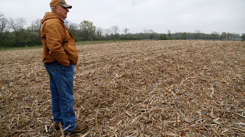 Ohio land values increased slightly in January compared to a year ago, from a $7,100 average sale price per acre to $7,300. In this May 2016 photo, Roderick Yocum looks over land on his Champaign County farm. BILL LACKEY/STAFF