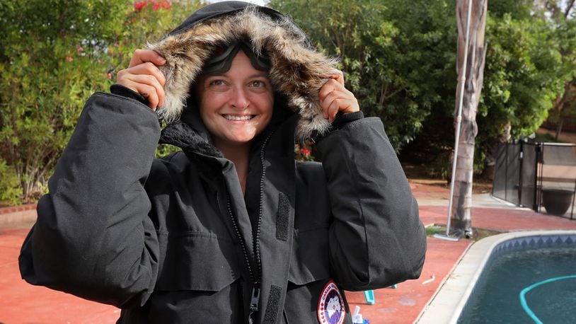 Aerospace engineer Rose Sandler tries on the bulky, extreme cold weather gear she&apos;ll be wearing while on an excursion soon to Outer Mongolia. (Charlie Neuman / San Diego Union-Tribune/TNS)