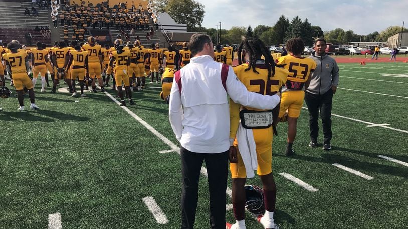Central State offensive coordinator Buddy Blevins (left) comforts junior wide receiver Micah Lowe after the Marauders' 34-14 loss to Miles. Tom Archdeacon/CONTRIBUTED