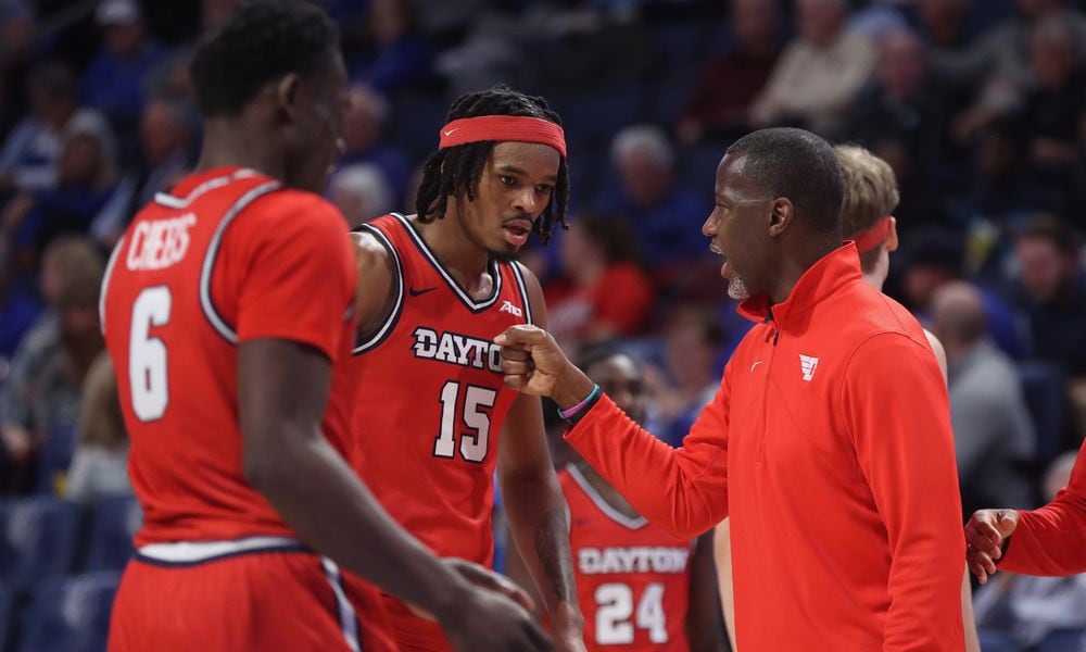 Dayton's Anthony Grant talks to DaRon Holmes II during a game against Saint Louis on Tuesday, March 5, 2024, at Chaifetz Arena in St. Louis, Mo. David Jablonski/Staff