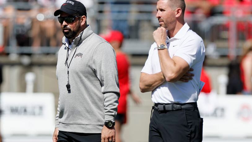 Ohio State head coach Ryan Day, left, and offensive coordinator Brian Hartline watch their team during their spring NCAA college football game, Saturday, April 15, 2023, in Columbus, Ohio. (AP Photo/Jay LaPrete)