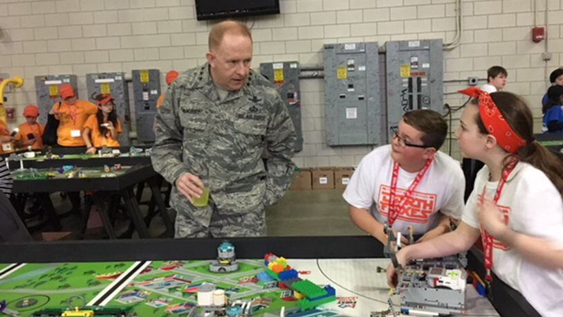 Two participants from Beavercreek explain the competition to Lt. Gen. Robert McMurry, Air Force Life Cycle Management Center commander. (U.S. Air Force photos/Marie Vanover)