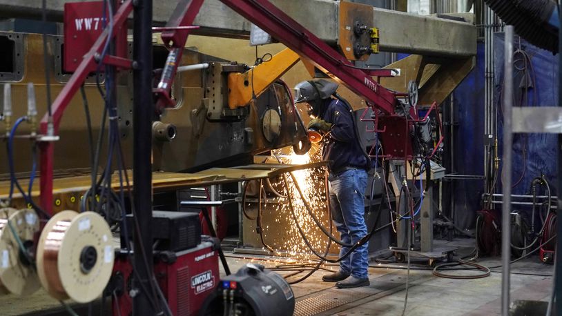 A worker grinds a weld on the latest version of the M1A2 Abrams main battle tank being built at the Joint Systems Manufacturing Center, Thursday, Feb. 16, 2023, in Lima, Ohio. (AP Photo/Carlos Osorio)