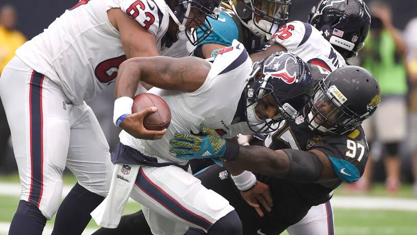 Houston Texans quarterback Deshaun Watson (4) is sacked by Jacksonville Jaguars defensive tackle Malik Jackson (97) during the second half of an NFL football game Sunday, Sept. 10, 2017, in Houston. (AP Photo/Eric Christian Smith)