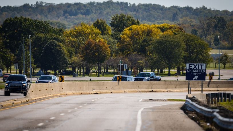 Vehicles move along Harshman Rd. near the National Museum of the United States Air Force. Riverside service director Kathy Bartlett says the city plans to replace the road and the wall as the wall is at the end of its useful life. JIM NOELKER/STAFF