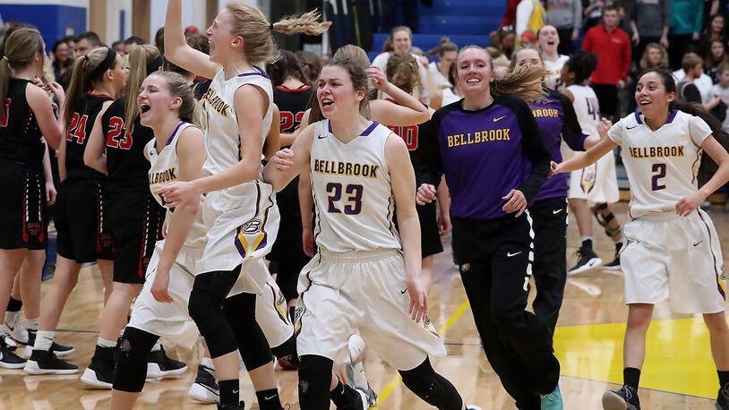 The Bellbrook girls basketball team celebrate the victory over Tipp Friday during the Regional finals at Springfield High School. Bill Lackey/Staff