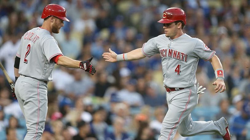 LOS ANGELES, CA - JUNE 10: Scooter Gennett #4 of the Cincinnati Reds is greeted by on deck batter Zack Cozart #2 after scorinig a run in the third inning against the Los Angeles Dodgers at Dodger Stadium on June 10, 2017 in Los Angeles, California. (Photo by Stephen Dunn/Getty Images)