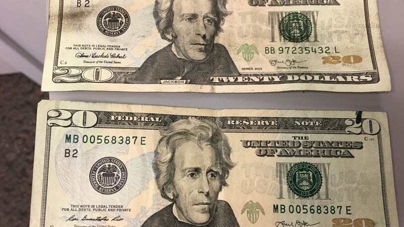Kenneth J. Stopkotte was found with several fake $20 bills during an April Dayton Dragons game, investigators alleged. One of the fakes (above) is shown with a real $20 bill. MARK GOKAVI/STAFF