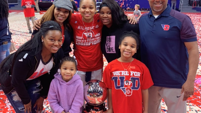 The Bradshaw Family at UD Arena after Flyers women won A-10 Tournament in March.
(in front) Adrienne (age 5, in purple) and Aubrie (age 8, in red); (Back Row, left to right) Amari (leaning over) mom Kelley, Araion, Ariel and dad Eric. CONTRIBUTED