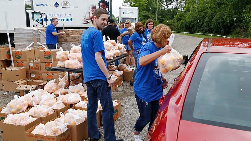 The Dayton Foodbank and Cox Media Group Ohio partnered with the North Dixie Drive In to aid in tornado relief efforts and gave away bottled water and food to those in need on Wednesday at the drive-in on North Dixie Drive.  Bags of fresh oranges were part of the distribution.  TY GREENLEES / STAFF