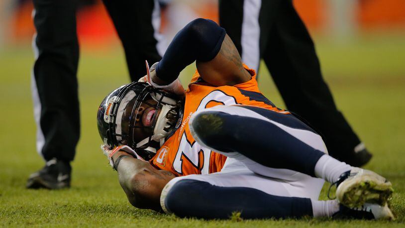 DENVER, CO - DECEMBER 28: Strong safety David Bruton #30 of the Denver Broncos lies on the ground in pain after a play that would force him out of the game with a reported concussion during a game against the Oakland Raiders at Sports Authority Field at Mile High on December 28, 2014 in Denver, Colorado. (Photo by Doug Pensinger/Getty Images)