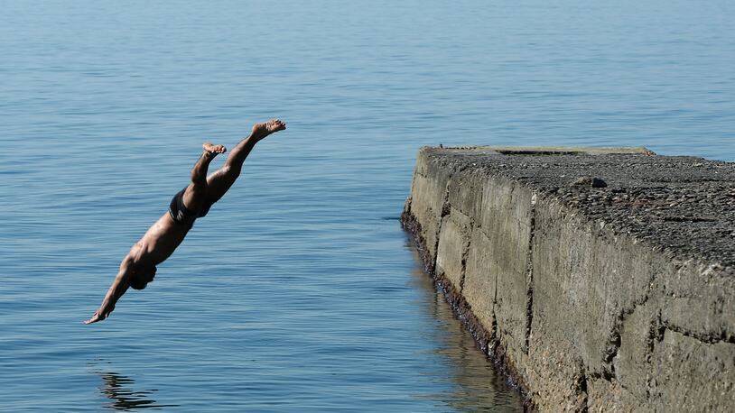 A man dives into the sea.  (Photo: Pascal Le Segretain/Getty Images)