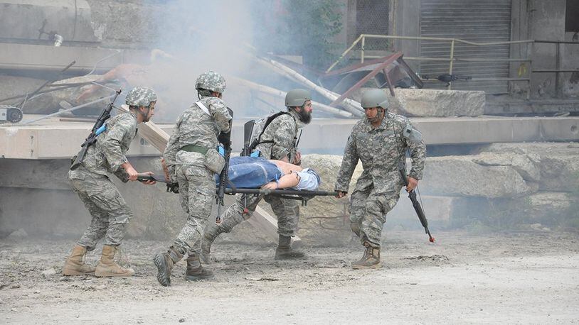 Air Force Research Laboratory Tech Warrior 2016 participants transport a casualty during a simulated battlefield scenario. The immersive experience is designed to give scientists and engineers insight into the battlefield environment in order to help in their design and function, of products and services, for the warfighter. (U.S. Air Force photo/Bill Hancock)