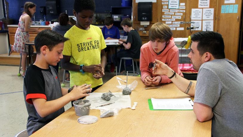 Matthew Szozda, an art teacher at W.O. Cline Elementary in Centerville, works with fifth-graders last school year. Szozda is one of 11 educators named a “2020 Teacher of the Year” by the Ohio Department of Education. CONTRIBUTED PHOTO