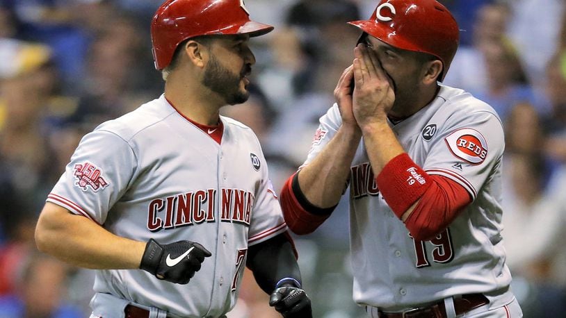 MILWAUKEE, WISCONSIN - JULY 22:  Eugenio Suarez #7 and Joey Votto #19 of the Cincinnati Reds celebrate after Suarez hit a home run in the seventh inning against the Milwaukee Brewers at Miller Park on July 22, 2019 in Milwaukee, Wisconsin. (Photo by Dylan Buell/Getty Images)