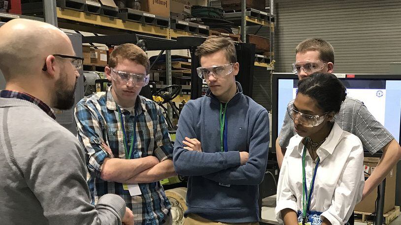 Dr. Eric Payton, materials research engineer, demonstrates the differences between two types of metals to students from local high schools. The students participated in the 2018 Spring Job Shadow Day at Wright-Patterson Air Force Base, where they spent the day learning about mechanical engineering career fields within the Air Force. (U.S. Air Force photo/Staff Sgt. Whitney Trimble)
