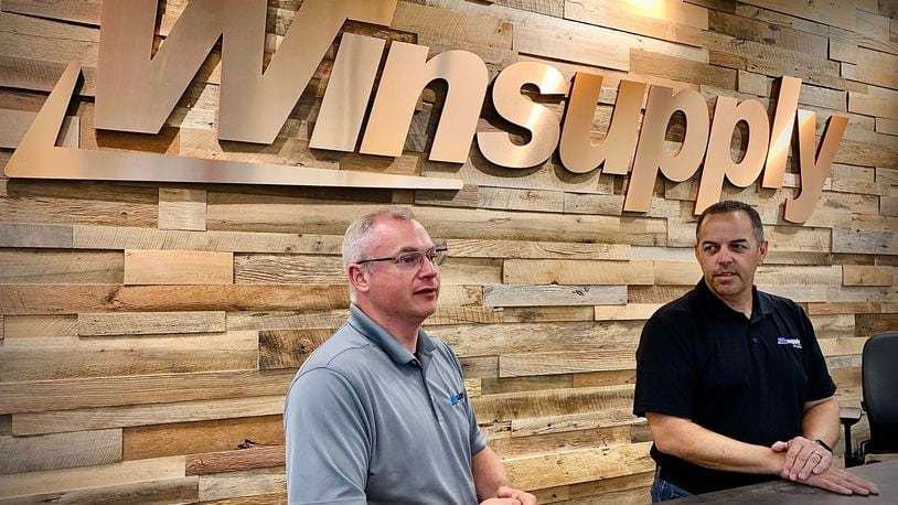 Bill Tolliver, Winsupply Inc.'s vice president of real estate services (left) and Jeff Williams, president of Winsupply of Dayton, talk about Winsupply's new Richard W. Schwartz Center for Innovation in Moraine. MARSHALL GORBY/STAFF