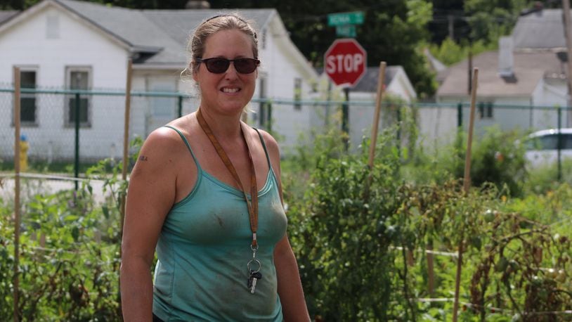 Lisa Helm, the founder of Dayton Urban Grown Farm, stands among the plantings at the co-op and training farm. Helm also founded Garden Station, which was evicted from a city-owned property last year. CORNELIUS FROLIK / STAFF