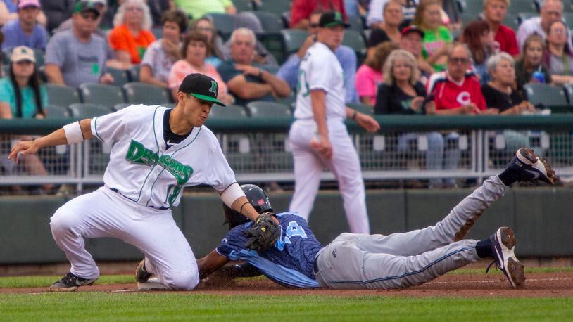 Dragons third baseman Victor Ruiz is late with the tag as West Michigan's Eric De La Rosa steals third right after stealing second. He scored the Whitecaps' first run during Friday night's game at Day Air Ballpark. Jeff Gilbert/CONTRIBUTED