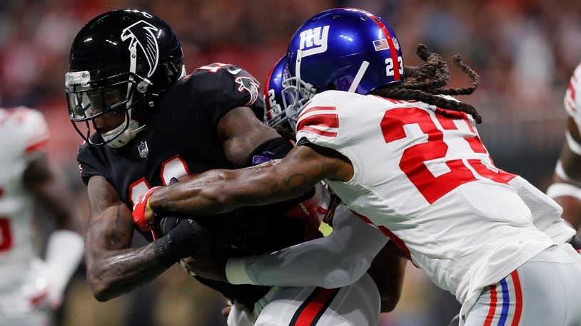 ATLANTA, GA - OCTOBER 22: Julio Jones #11 of the Atlanta Falcons is tackled by B.W. Webb #23 of the New York Giants and Alec Ogletree #52 of the New York Giants after carrying a reception during the second quarter against the New York Giants at Mercedes-Benz Stadium on October 22, 2018 in Atlanta, Georgia. (Photo by Kevin C. Cox/Getty Images)