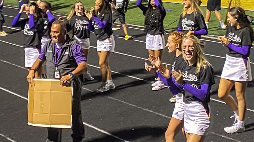 The student section cheered on school safety officer Settich as he encouraged school spirit during a recent Friday night football game at Vandalia Butler. Courtesy of Vandalia-Butler.