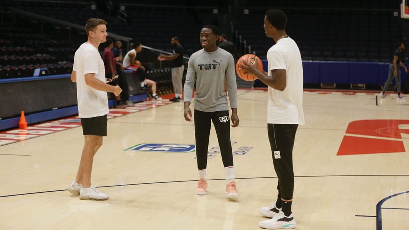 Joey Gruden, Jeremiah Bonsu and Jordan Sibert talk at the Red Scare practice on Tuesday, July 19, 2022, at UD Arena. The Dayton alumni team plays in The Basketball Tournament on Sunday. David Jablonski/Staff