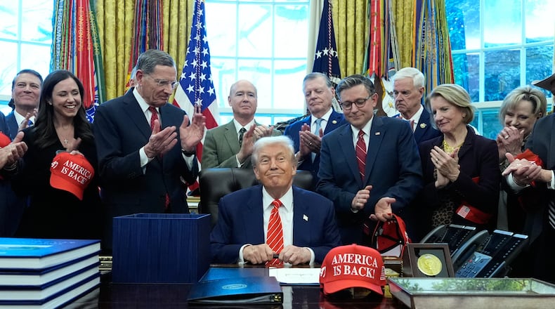 President Donald Trump smiles after signing a spending bill that ends a partial shutdown of the federal government in the Oval Office of the White House, Tuesday, Feb. 3, 2026, in Washington. (AP Photo/Alex Brandon)
