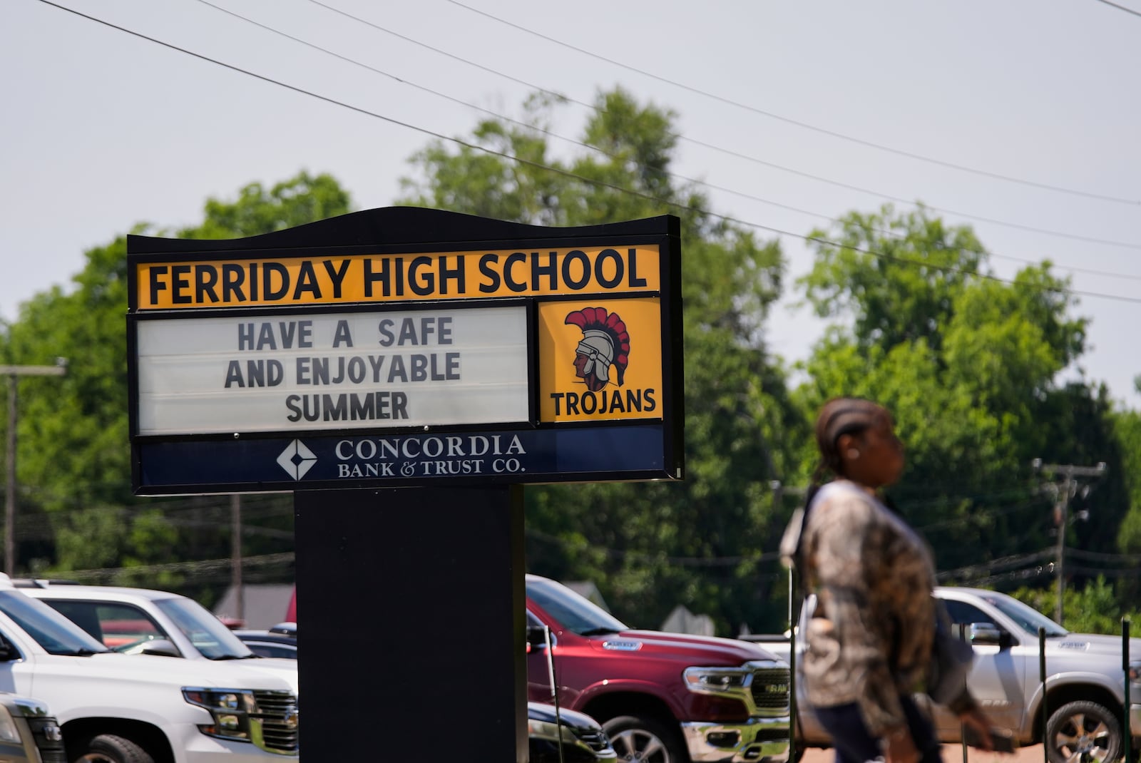 A person walks in front of Ferriday High School in Ferriday, La., Thursday, May 22, 2025. (AP Photo/Gerald Herbert)