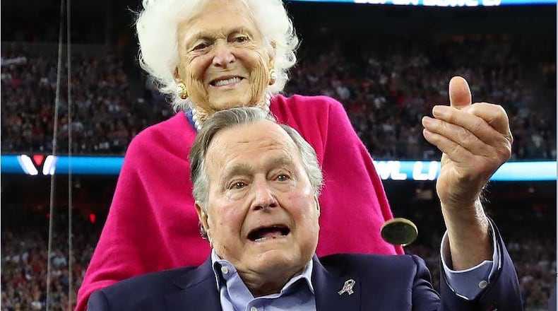 President George H.W. Bush, shown here with his wife Barbara, died Friday at age 94 in Houston.
