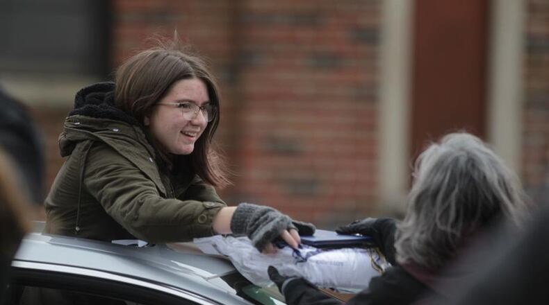 The Oakwood Historical Society is embarking on an ambitious project to capture the effects of the coronavirus pandemic on the community. Oakwood High School hosted a cap and gown drive-thru celebration Tuesday behind the high school. Seniors were encouraged to decorate their cars while teachers handed out caps, gowns and diplomas. The school plans a virtual graduation on May 26. JIM NOELKER/STAFF
