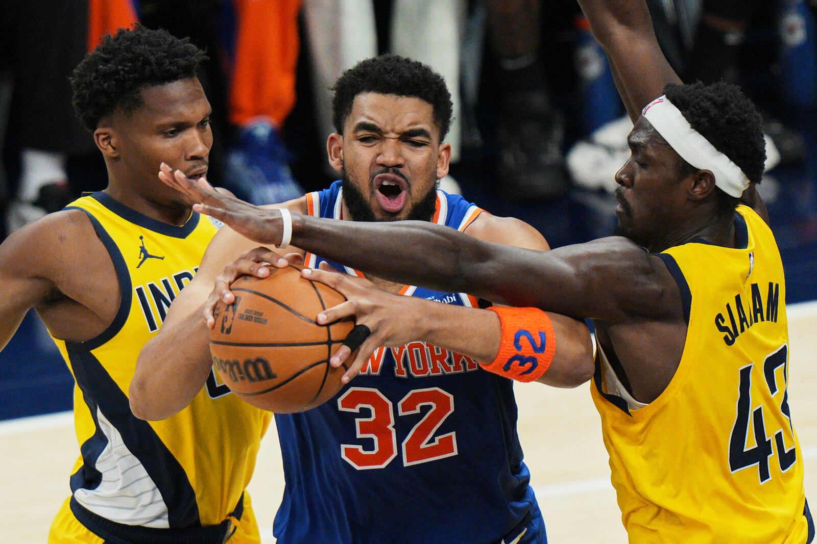 New York Knicks center Karl-Anthony Towns (32) tries to get past Indiana Pacers forward Pascal Siakam (43) and Indiana Pacers guard Bennedict Mathurin, left, during the first half of Game 4 of the Eastern Conference finals of the NBA basketball playoffs in Indianapolis, Tuesday, May 27, 2025. (AP Photo/AJ Mast)