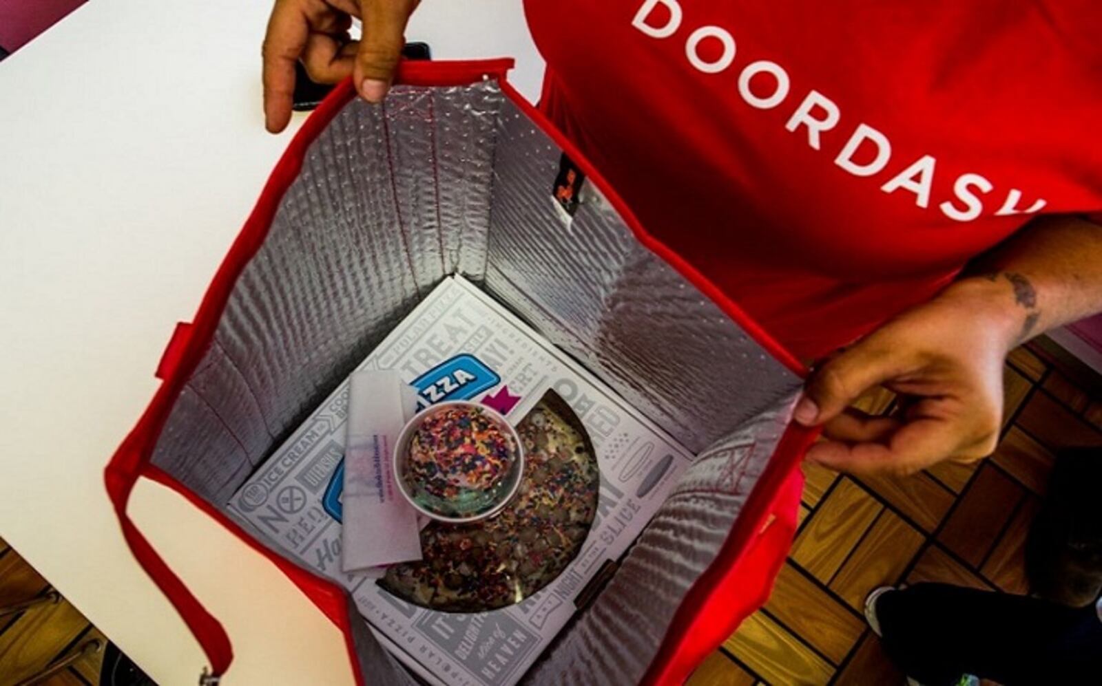 A DoorDash driver starts to bag up an order in Daly City, Calif. MUST CREDIT: Photo by Christie Hemm Klok for The Washington Post.