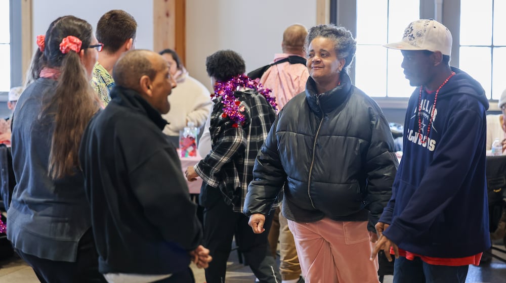 Participants dance during Goodwill Easterseals' Valentine's Dance on Thursday, Feb. 12 at Lost Creek Reserve in Troy. Goodwill Easterseals held a catered lunch, games, crafts and dancing for people with developmental disabilities, caregivers and service and support administration workers. BRYANT BILLING / STAFF